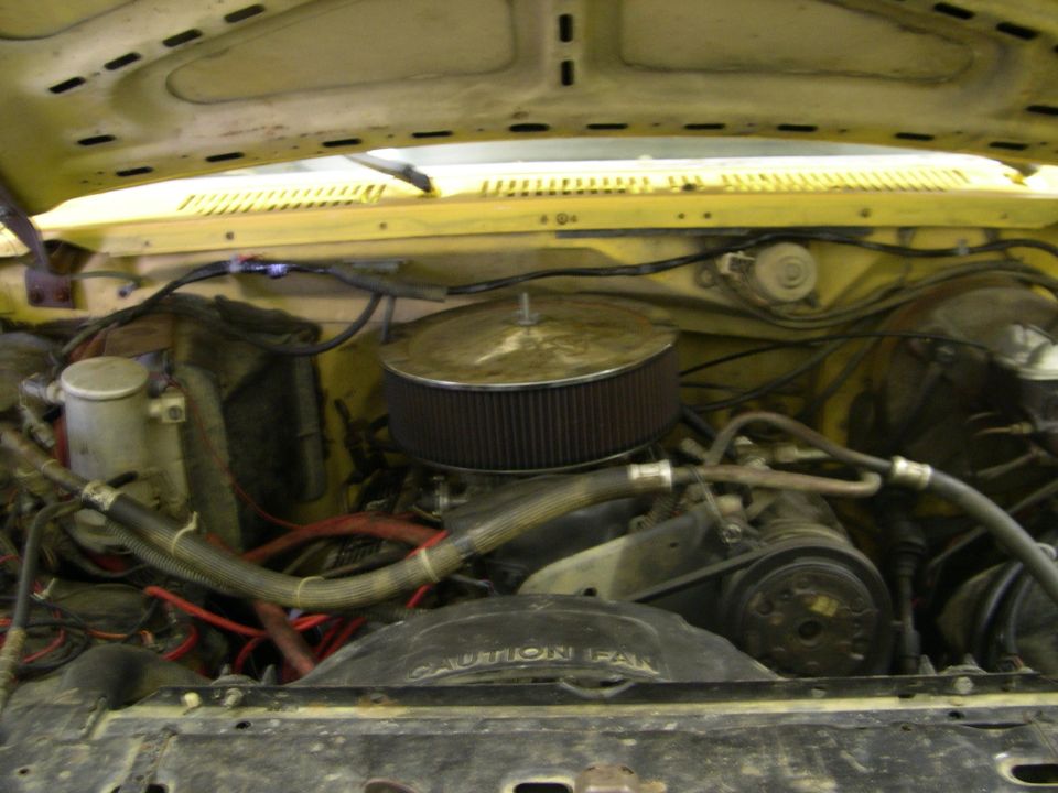engine bay with air filter, hoses, and fan visible. Text on fan reads 'CAUTION FAN'. Watermark says 'SUPERMOTORS www.supermotors.net'