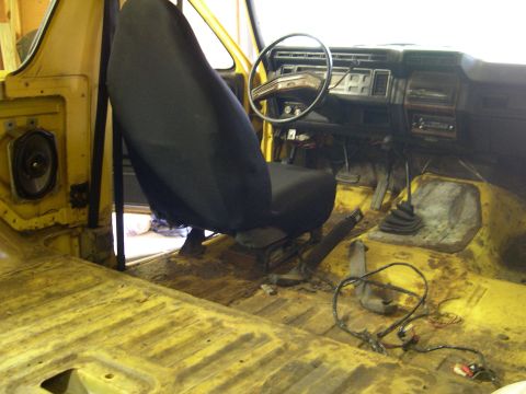 1982 Ford Bronco - Interior view of a 1982 Ford Bronco, showing the dashboard, seat, and floor.