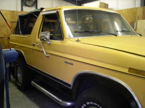 1982 Ford Bronco - This yellow 1982 Ford Bronco is shown from the front quarter angle in an indoor setting.