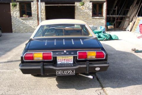 1978 Ford Mustang II - Rear view of a black 1978 Ford Mustang II with a tan vinyl roof and New Jersey plates.