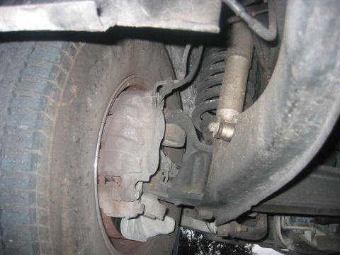 1989 Ford Bronco - This image shows the brake caliper and suspension system of a vehicle, not specific year or model details.