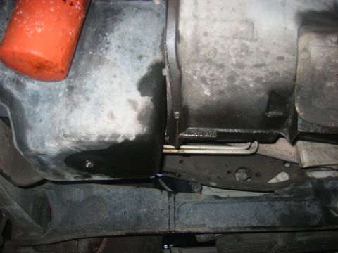 1989 Ford Bronco - Underside view of engine components showing an oil filter and a leak.