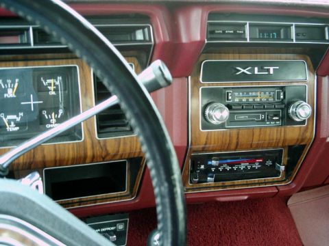 1984 Ford Bronco - Dashboard view of a 1984 Ford Bronco XLT, woodgrain trim and an aftermarket stereo system.