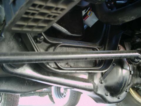1984 Ford Bronco - Undercarriage view of a vehicle, suspension components and a NAPA oil filter. The year is not discernible from this angle.