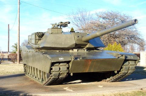 1998 Ford Crown Victoria - A military tank is displayed outdoors under a clear blue sky.