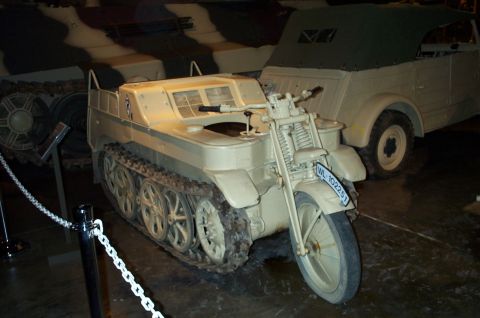 1998 Ford Crown Victoria - A Kettenkrad, a German World War II era half-track motorcycle, is displayed in a museum setting.