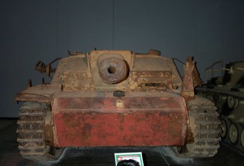 1998 Ford Crown Victoria - A weathered Sturmgeschütz III assault gun is displayed next to another tracked vehicle in a museum setting.