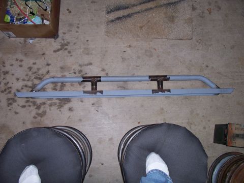 1982 Ford Bronco - Custom rock sliders, likely for an off-road vehicle, are shown laid out on a concrete floor.