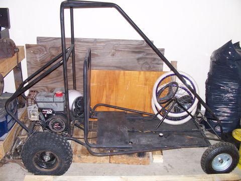 1982 Ford Bronco - A black go-kart with a small engine and two wheels is shown from the side.