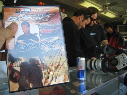1990 Ford Bronco - photo of a signed racing DVD case, not a vehicle technical document.