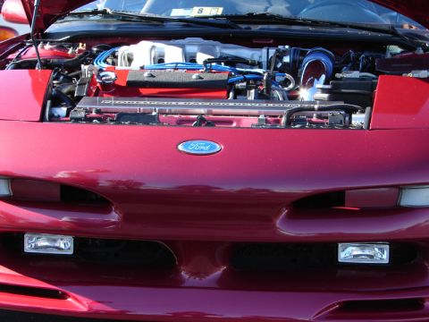 1994 Ford Probe - Front view of a red 1994 Ford Probe with the hood open, revealing the engine compartment and Ford badging.