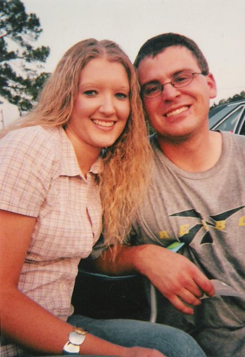 1999 Ford Mustang - Couple posing for a photo, with a car partially visible in the background.