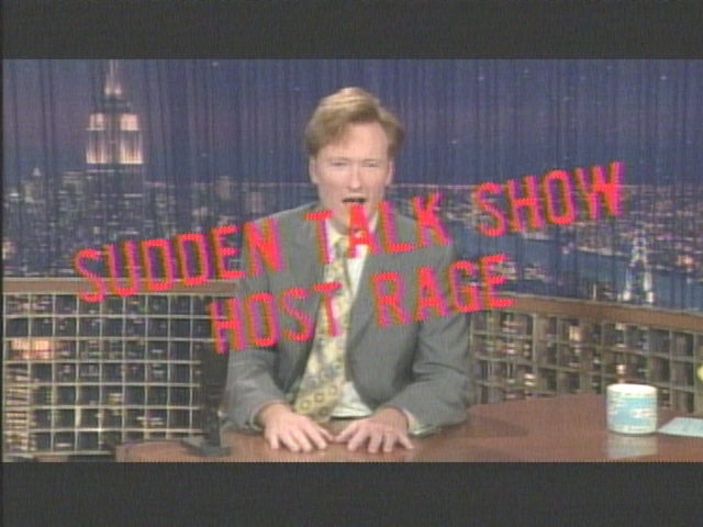 Conan O'Brien sits at a desk on a talk show set with a city skyline backdrop. Red text reads 'SUDDEN TALK SHOW HOST RAGE'