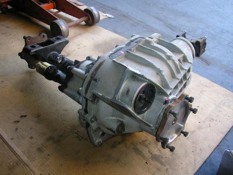 1979 Chevrolet C/K Pickup - A differential assembly, likely from a truck, is shown on a flat surface with a floor jack in the background.