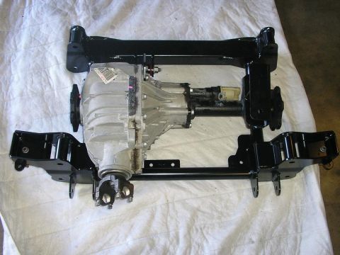 1979 Chevrolet C/K Pickup - A rear differential assembly is shown mounted on a black metal frame, resting on a white cloth surface.