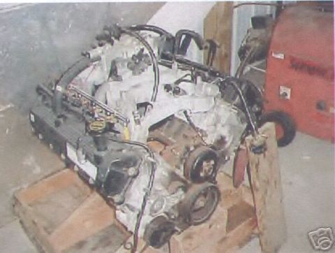 2000 Mercury Grand Marquis - Engine assembly shown on a wooden stand, likely for repair or replacement.