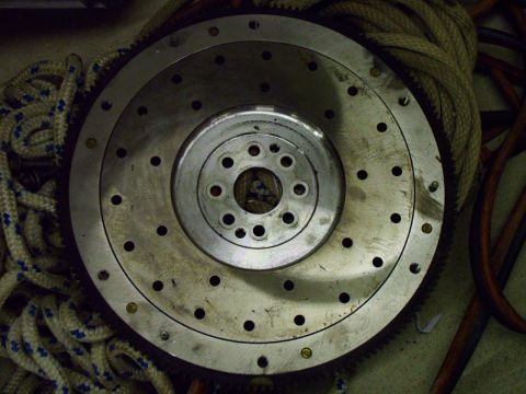 2003 Ford Mustang - A metal flywheel, likely a car part, is shown with ropes in the background.