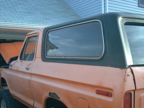 1978 Ford Bronco - This 1978 Ford Bronco is seen from the side with its hood up, revealing its orange paint and black hardtop.