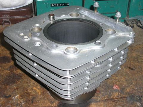 1900 Honda Big Red - A close-up view of an engine cylinder block, likely from a motorcycle, with visible cooling fins.