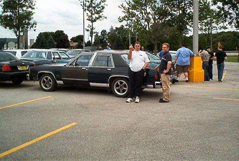 1985 Ford LTD Crown Victoria - A 1985 Ford Crown Victoria LTD is seen parked in a lot with two men standing nearby.
