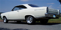 1966 Ford Fairlane - A white 1966 Ford Fairlane is parked outdoors on a sunny day, viewed from the rear quarter.