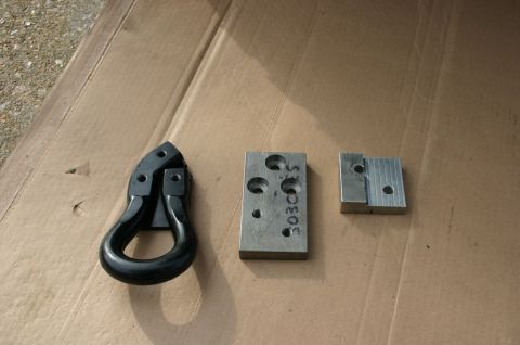 1994 Ford Bronco - Recovery tow hitch shackle and mounting blocks shown on cardboard.