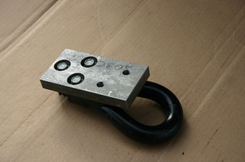 1994 Ford Bronco - A metal tow hook assembly with a black loop is shown attached to a silver plate with visible text.
