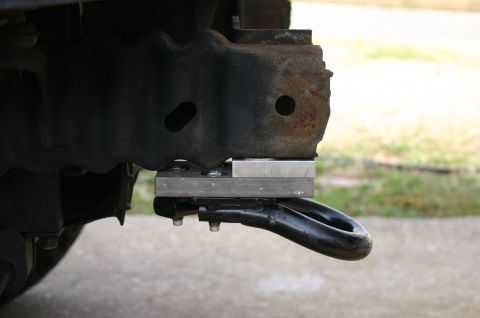 1994 Ford Bronco - A close-up view of a tow hook assembly mounted to a vehicle's frame.
