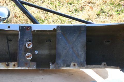 1994 Ford Bronco - Close-up view of a vehicle's frame and bumper mounting hardware, showing signs of wear and rust.