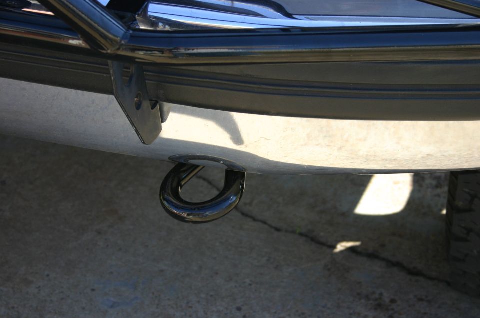 Close-up of a black tow hook attached to a vehicle's bumper