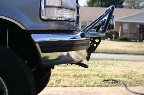 1994 Ford Bronco - Close-up of a truck's front end, showing the bumper and an aftermarket brush guard.