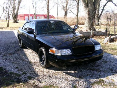 2001 Ford Crown Victoria - 2001 Ford Crown Victoria with a blacked-out grille and aftermarket wheels.