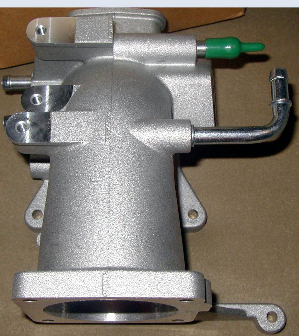 Aluminum intake manifold with green cap and metal tube fittings