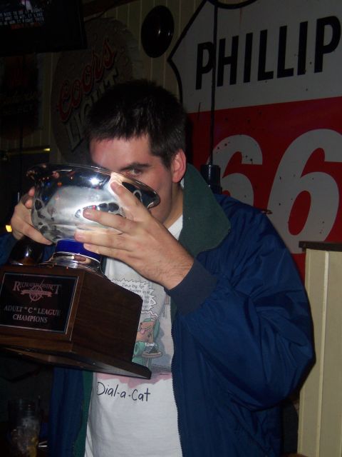1985 Ford LTD Crown Victoria - Man drinks from a trophy, with Route 66 and Coors Light signs in the background.