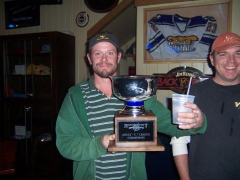 1985 Ford LTD Crown Victoria - Two men pose for a photo, one holding a large trophy, in what appears to be a bar or pub.