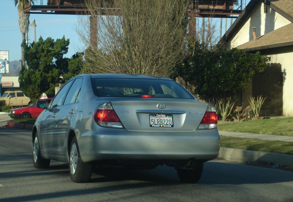 Silver sedan from rear, license plate 5LRB220. Third brake light illuminated