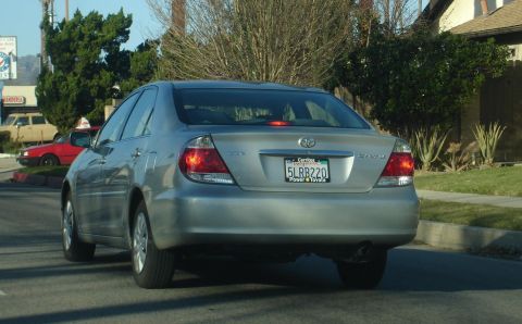 1993 Ford Taurus - This silver sedan has a rear view with license plate 5LRB220. The body style suggests a 2002 model year.
