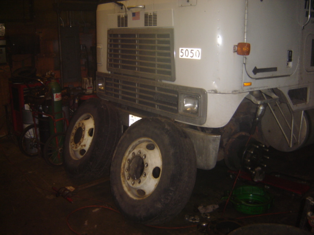 Front grille and dual wheels of a large truck, with a "5050" sticker on the cab