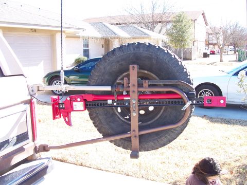 1982 Ford Bronco - This 1982 Ford Bronco features a rear-mounted spare tire carrier equipped with a Hi-Lift jack, ready for off-road adventures.
