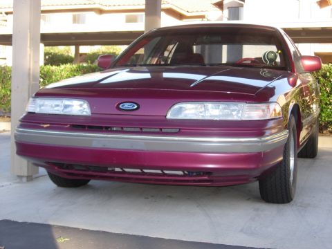 1992 Ford Crown Victoria - Front view of a maroon 1992 Ford Crown Victoria parked under a carport.