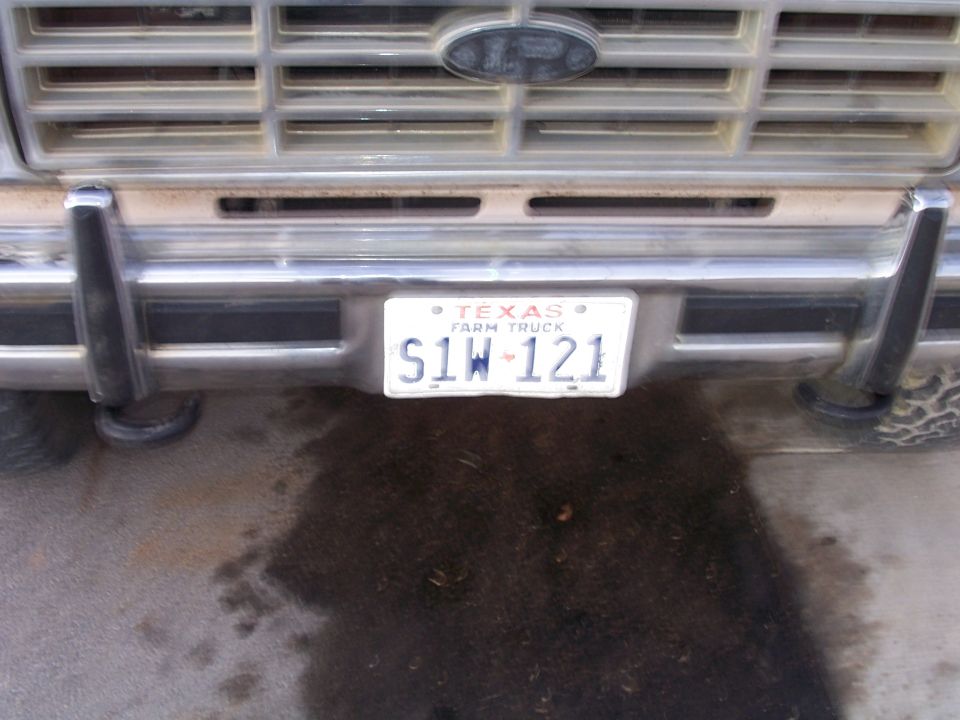 Front of a Ford truck with a Texas Farm Truck license plate