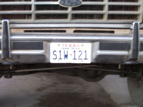 1982 Ford Bronco - Close-up of a Texas Farm Truck license plate mounted on a vehicle's front bumper.