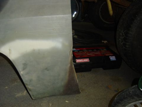 1987 Suzuki Samurai - Unpainted metal panel with primer and rust, next to a Craftsman toolbox.
