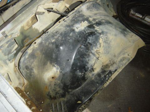 1987 Suzuki Samurai - This image shows a fender well, heavily weathered with rust and dirt, suggesting it is a part from a vehicle.