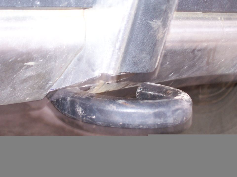 Close-up of a black tow hook attached to a silver vehicle frame