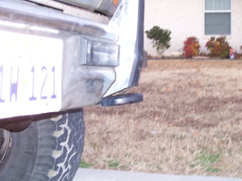 1982 Ford Bronco - Close-up view of a vehicle's rear bumper, tire, and license plate.