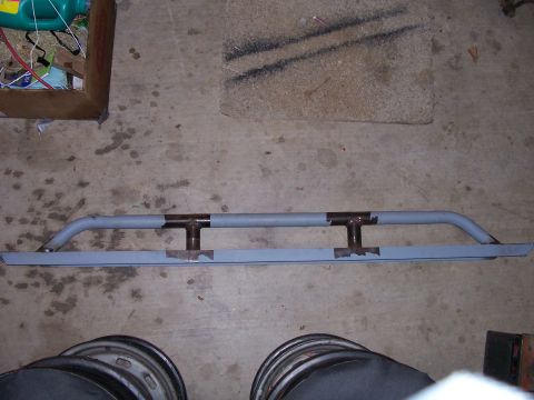 1982 Ford Bronco - A custom fabricated front bumper is shown, likely for an off-road vehicle, resting on a garage floor.