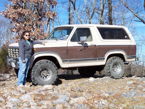 1982 Ford Bronco - A woman poses with a lifted 1982 Ford Bronco on a rocky trail.