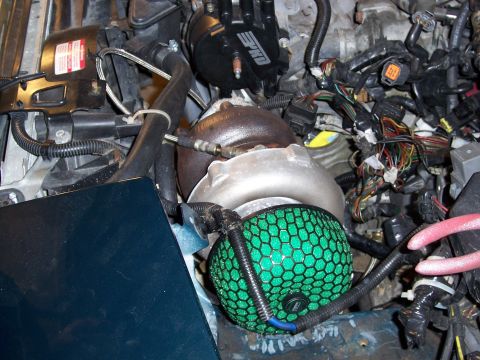 1997 Ford Probe - Close-up of engine components including a turbocharger and aftermarket air filter.