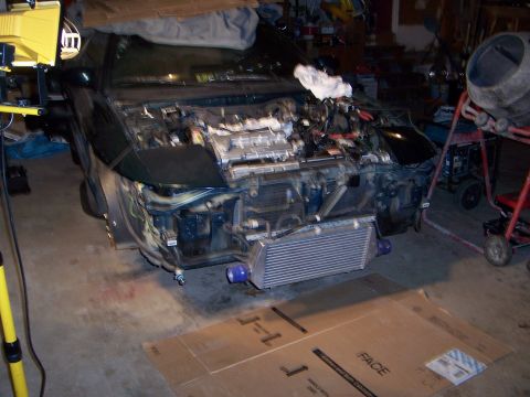 1997 Ford Probe - The front end of a 1997 Ford Probe is disassembled, revealing the engine and intercooler.